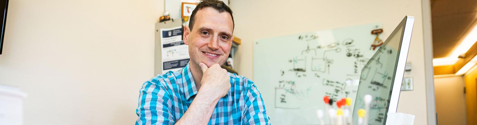 Prof Jason Hein sitting in his office at UBC Vancouver