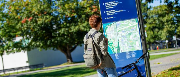UBC student looking at a map on campus