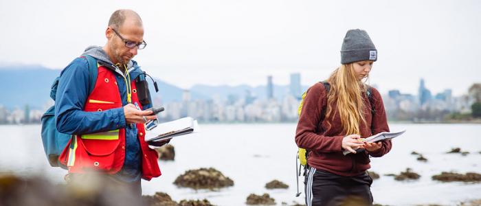 UBC student and professor gathering field data by the ocean