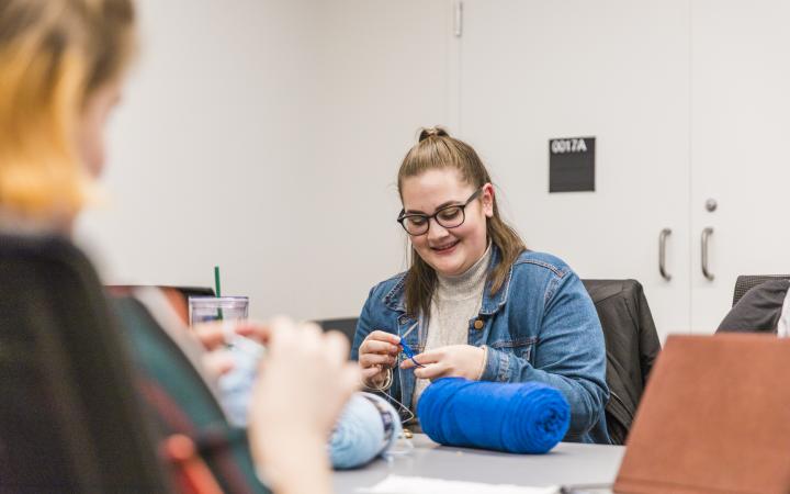 Club members knitting and sewing