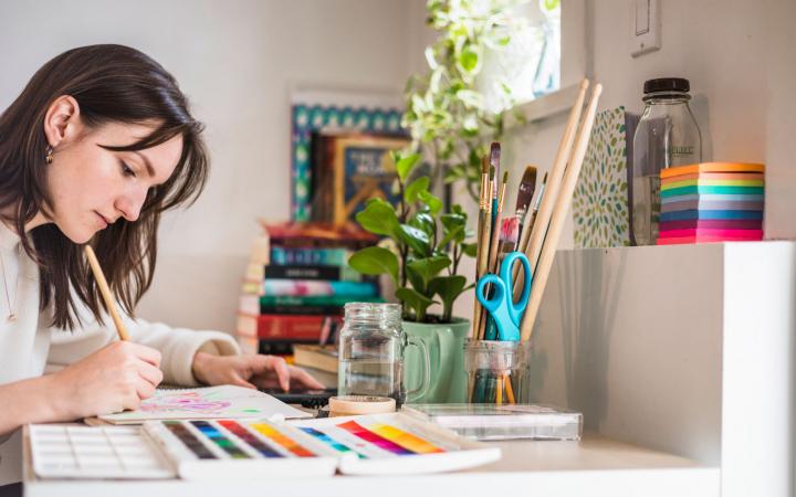 A student sitting at her desk, journalling