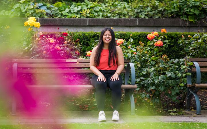 Student sitting in the Rose Garden